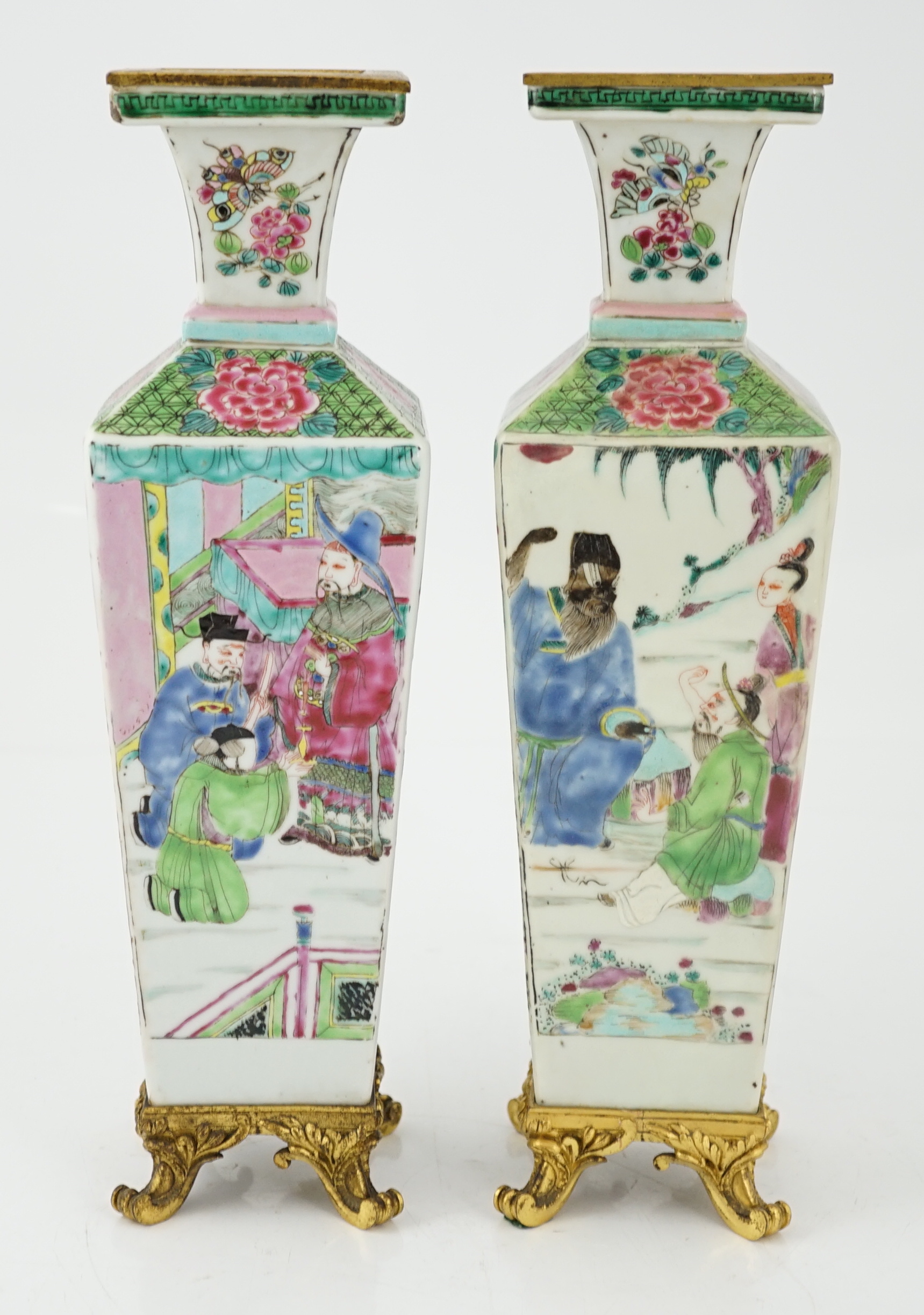 A pair of Chinese famille rose square baluster vases, late 19th/early 20th century, with European gilt metal mounts, each painted with figure scenes, total height 32cm